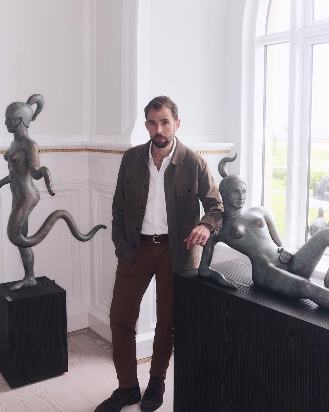 Andreas Zinck Henningsen, co-founder of Edition Solenne, photographed with bronze sculptures